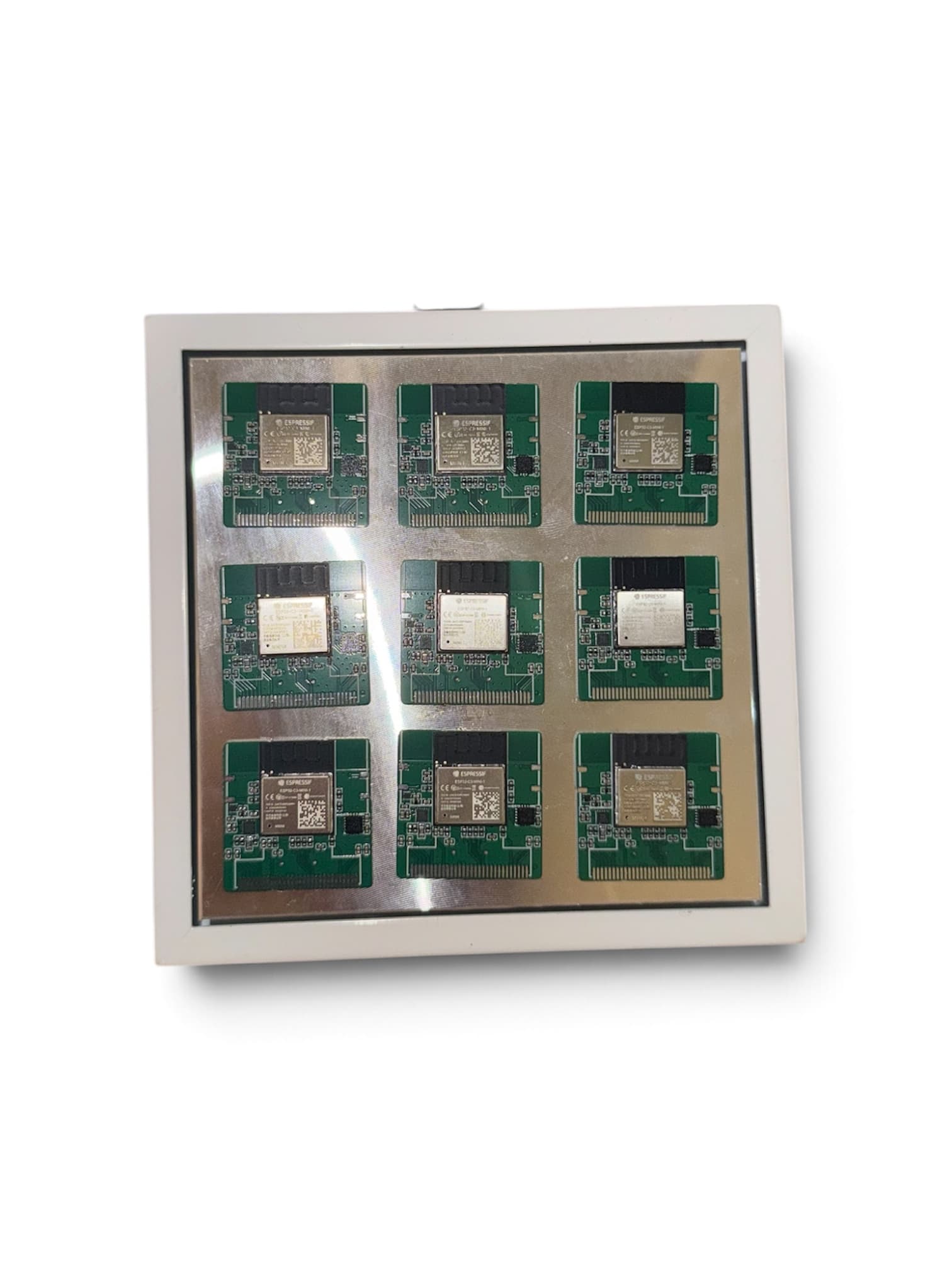 Nine of Moji’s final circuit boards arranged on a metal tray during assembly.